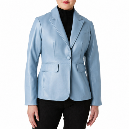 A woman wearing a light blue faux-leather blazer over a black turtleneck sweater and black pants, shown from the lips down against a plain white background.